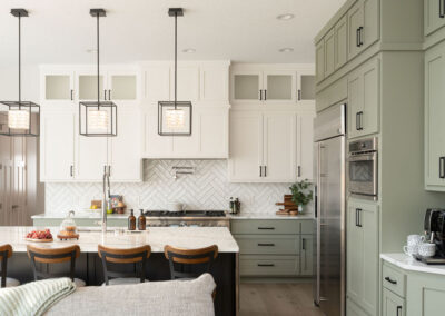 Two-tone kitchen cabinet painting. Green and cream cabinets