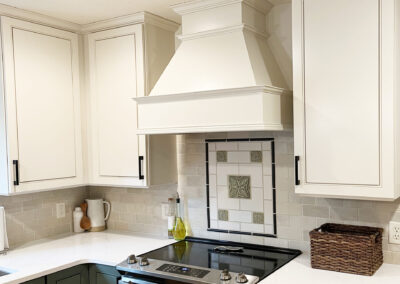Painted kitchen cabinets, bottom green, top cream.